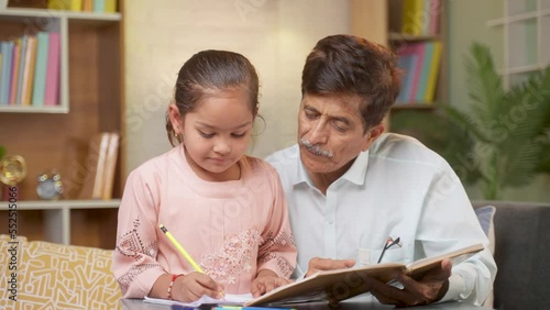 爷爷帮助他的孙女在家学习，从教科书的概念教学